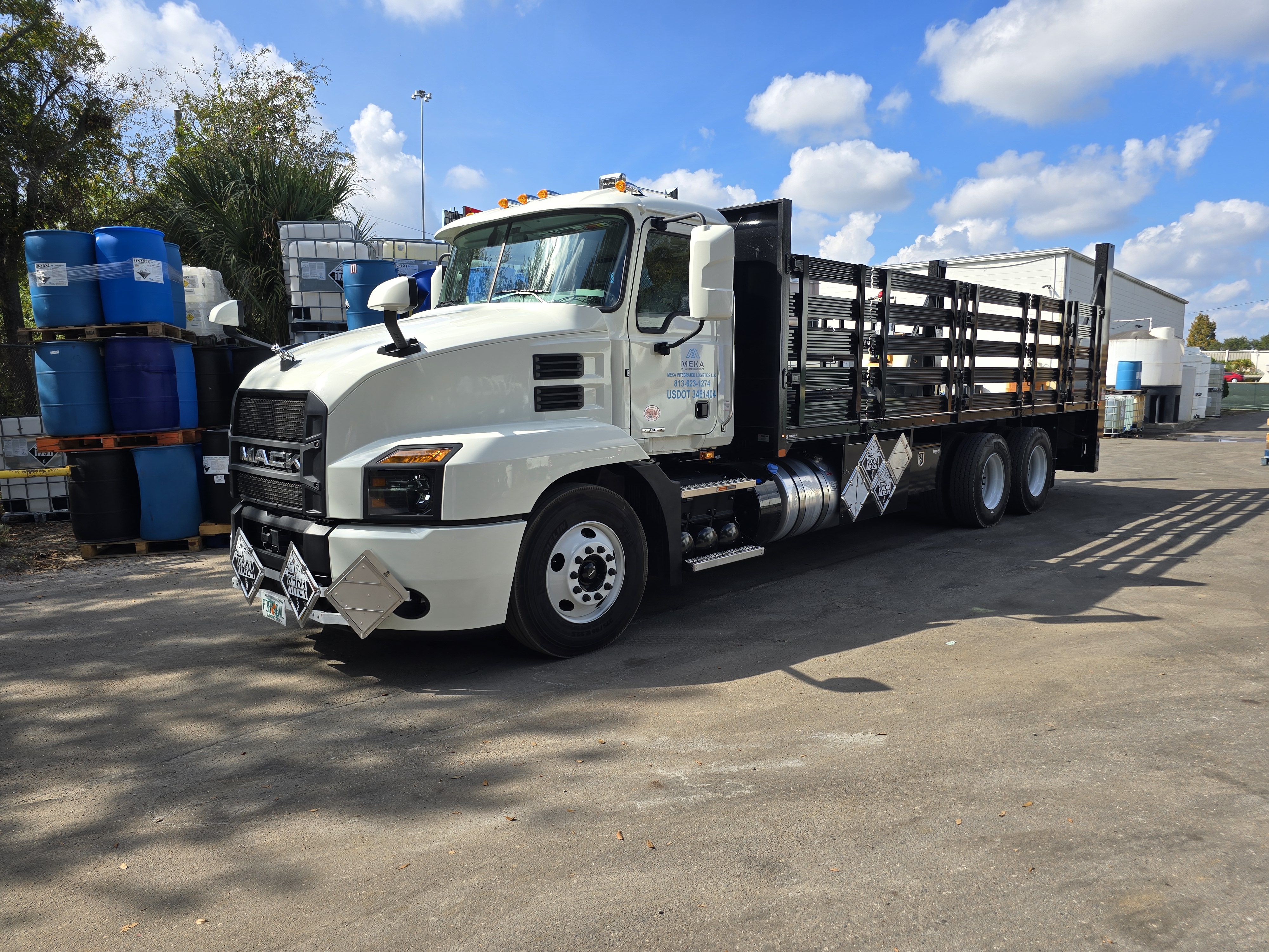 White Mack truck with hazmat placards