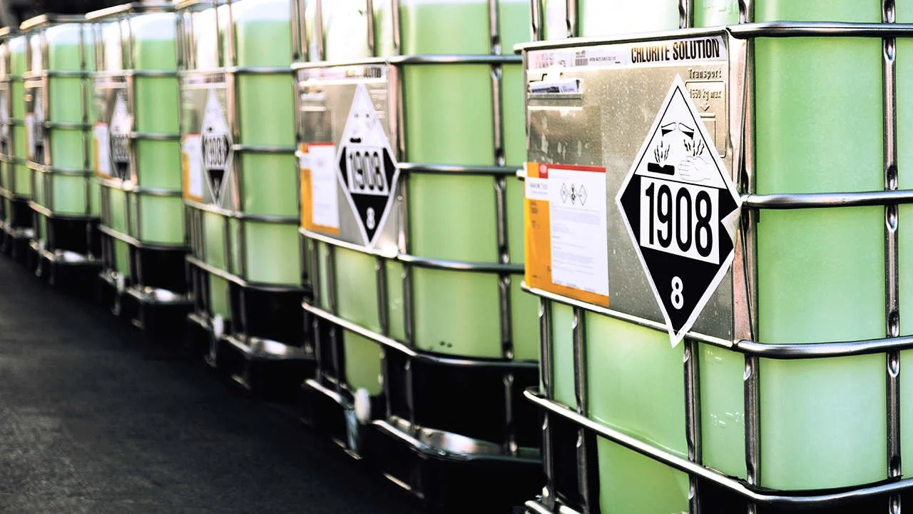 IBC totes with DOT hazmat placards — chemical downpacking and packaging