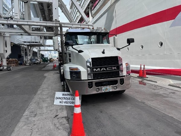 Mack truck at Port of Miami with cruise ship in background