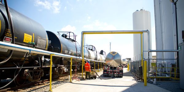 Rail tank cars and tanker truck at a chemical transloading facility